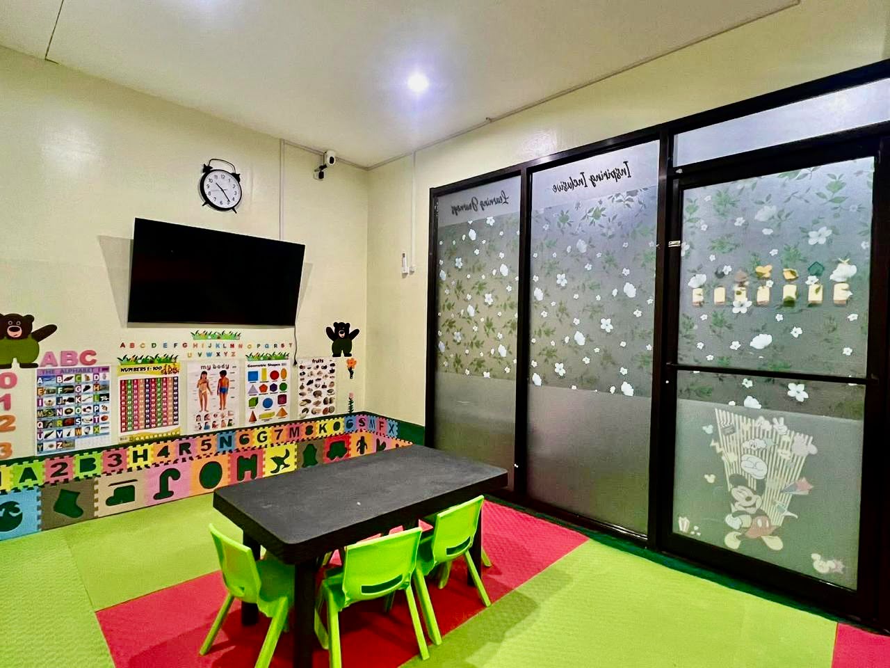 Classroom with frosted glass doors and learning wall