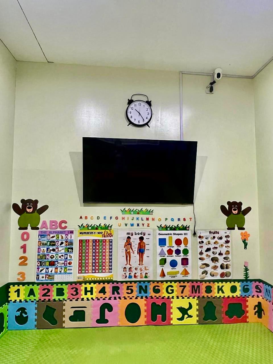 Learning wall with TV and educational charts