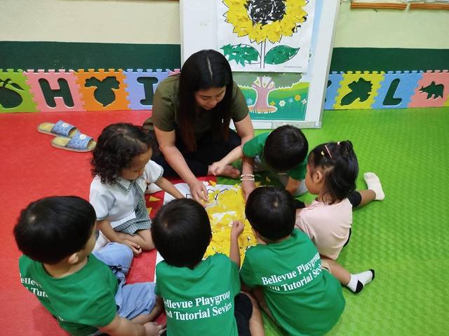 A teacher with a group of young learners at Bellevue